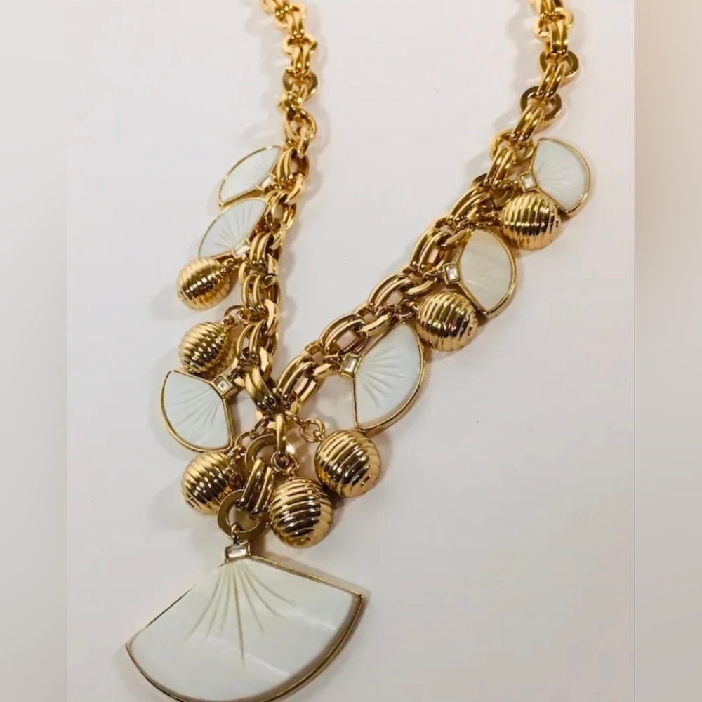 Vintage Avon shell charm necklace featuring gold-tone fan and shell charms